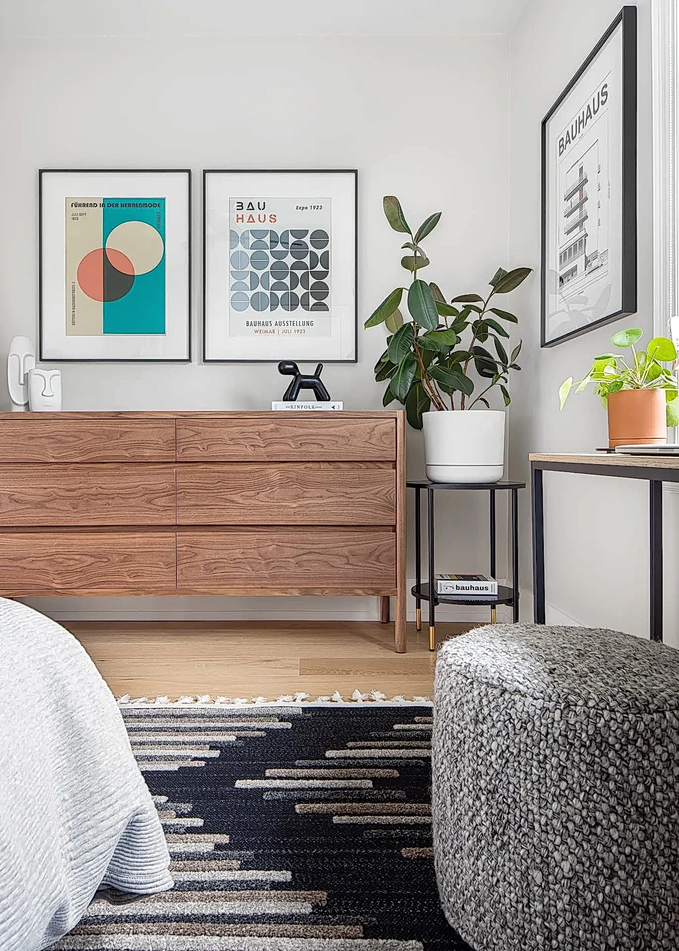 Bright and airy mid-century modern bedroom with wood dresser and wood bed frame