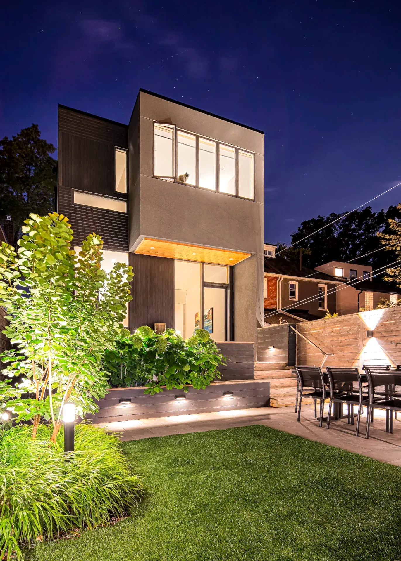 Modern backyard patio with outdoor dining area and couch seating