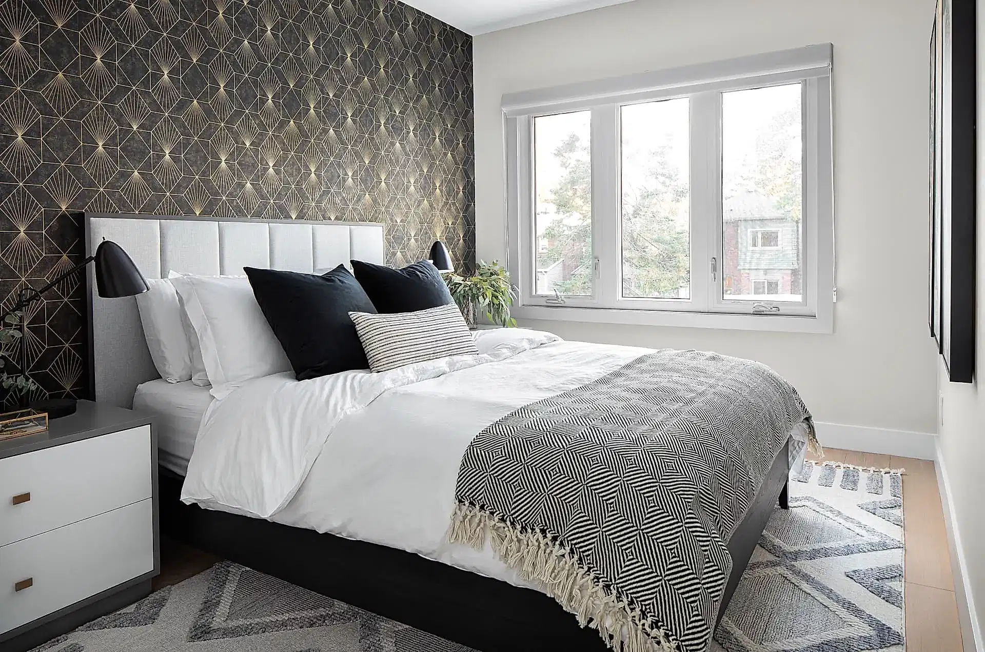 Bright white and bold geometric contemporary primary bedrooom