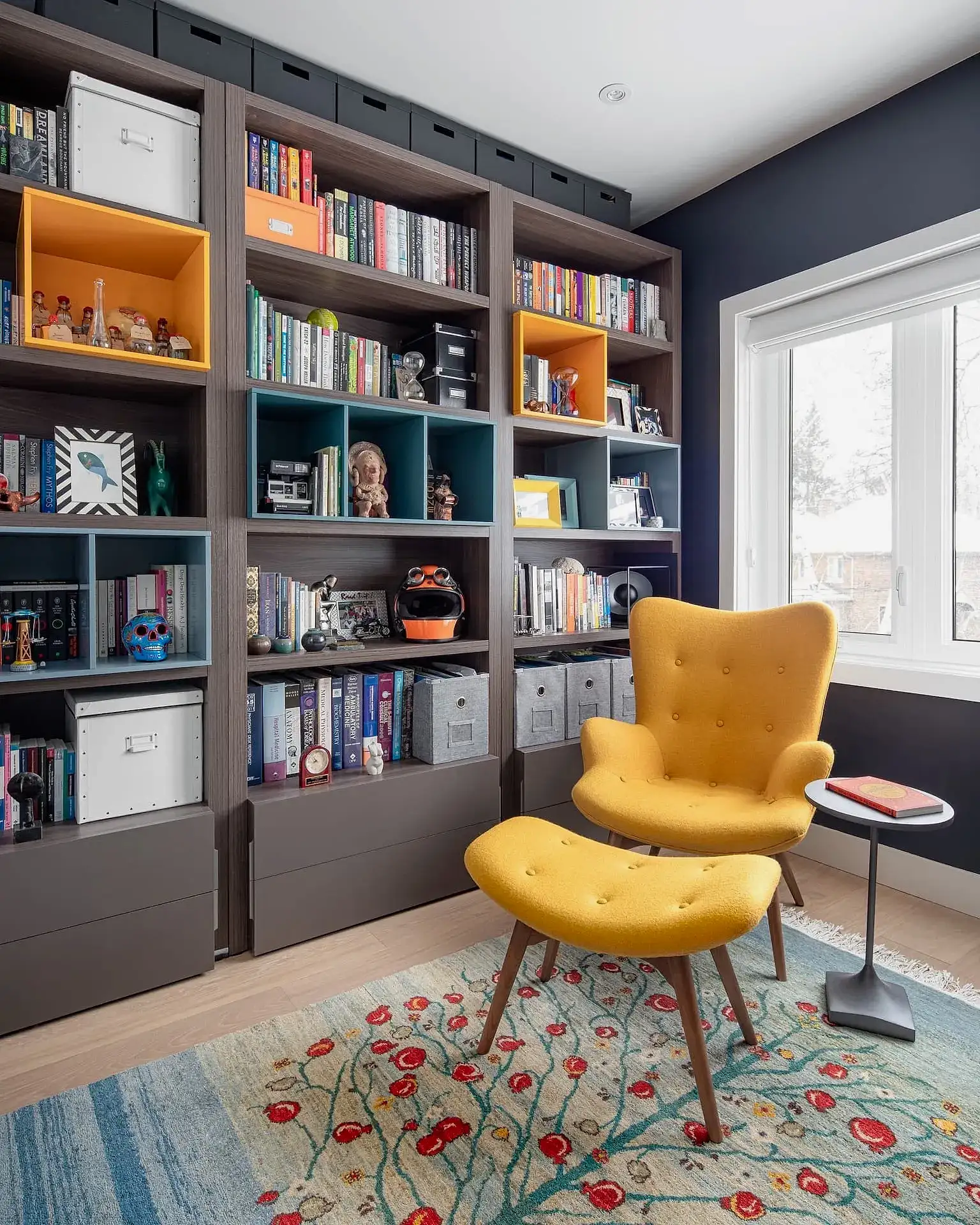 Cozy mid-century modern home office with wood bookcase and yellow velvet reading chair