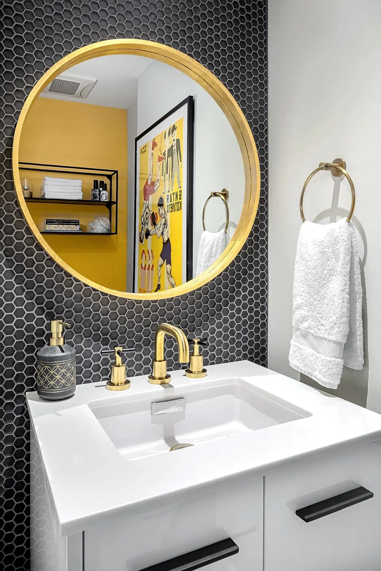 High contrast contemporary powder room with gold hardware and black tile accent wall