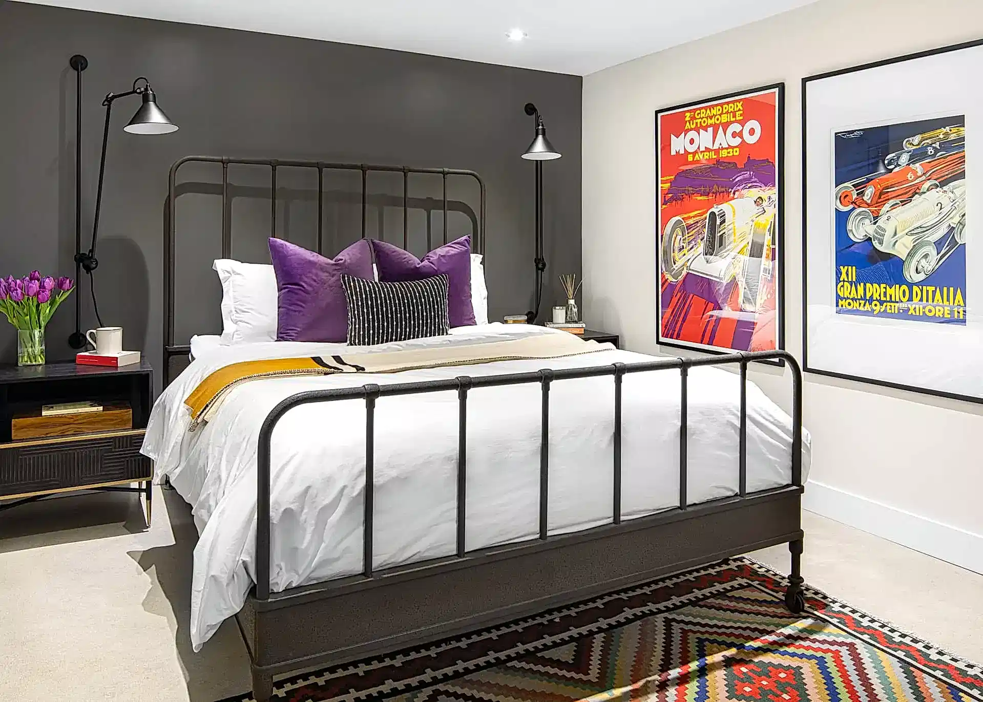 Retro modern bedroom with metal frame bed and blue and yellow posters of cars
