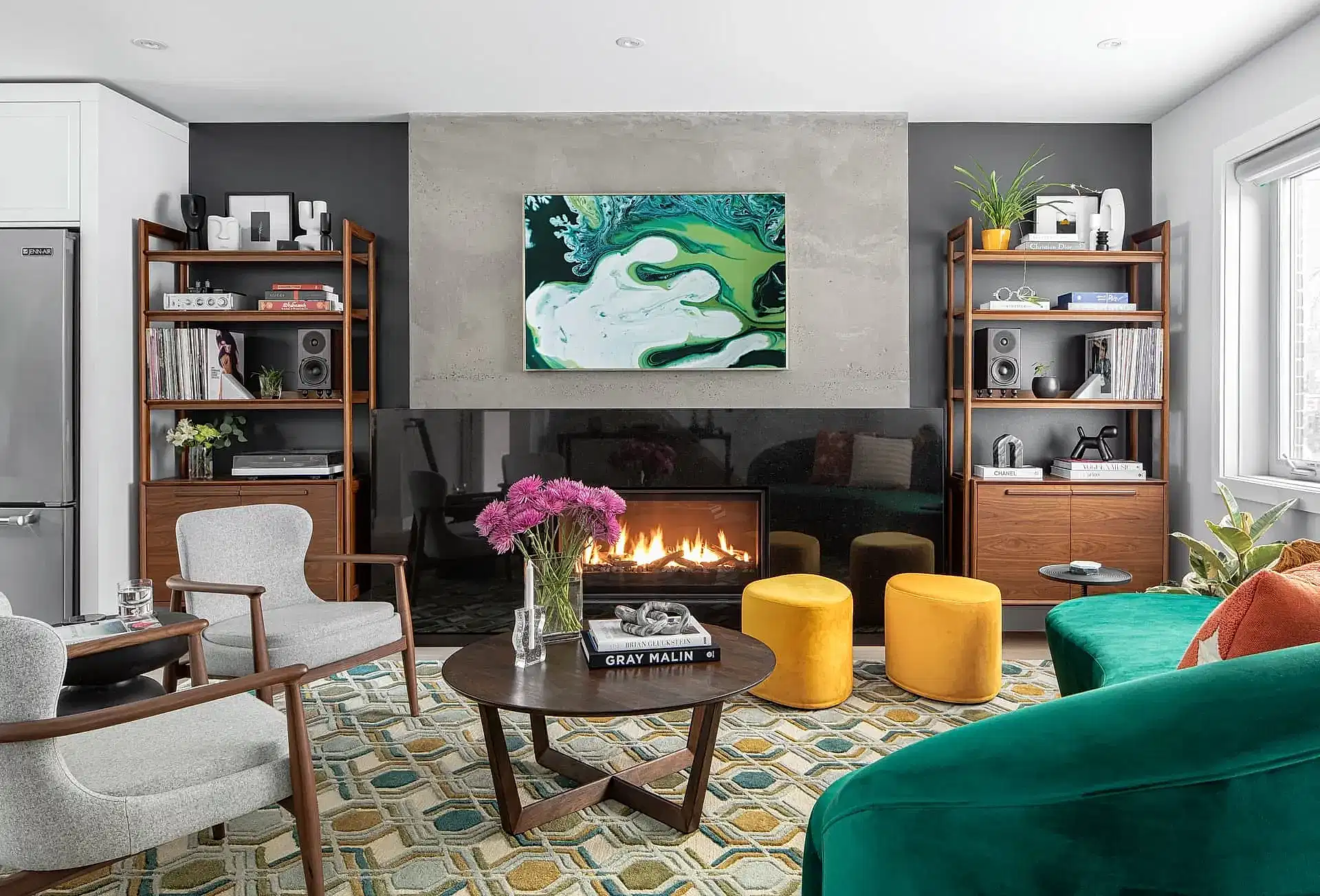 Colour mid-century modern living room with wood shelves and green couch at Valleyview Project