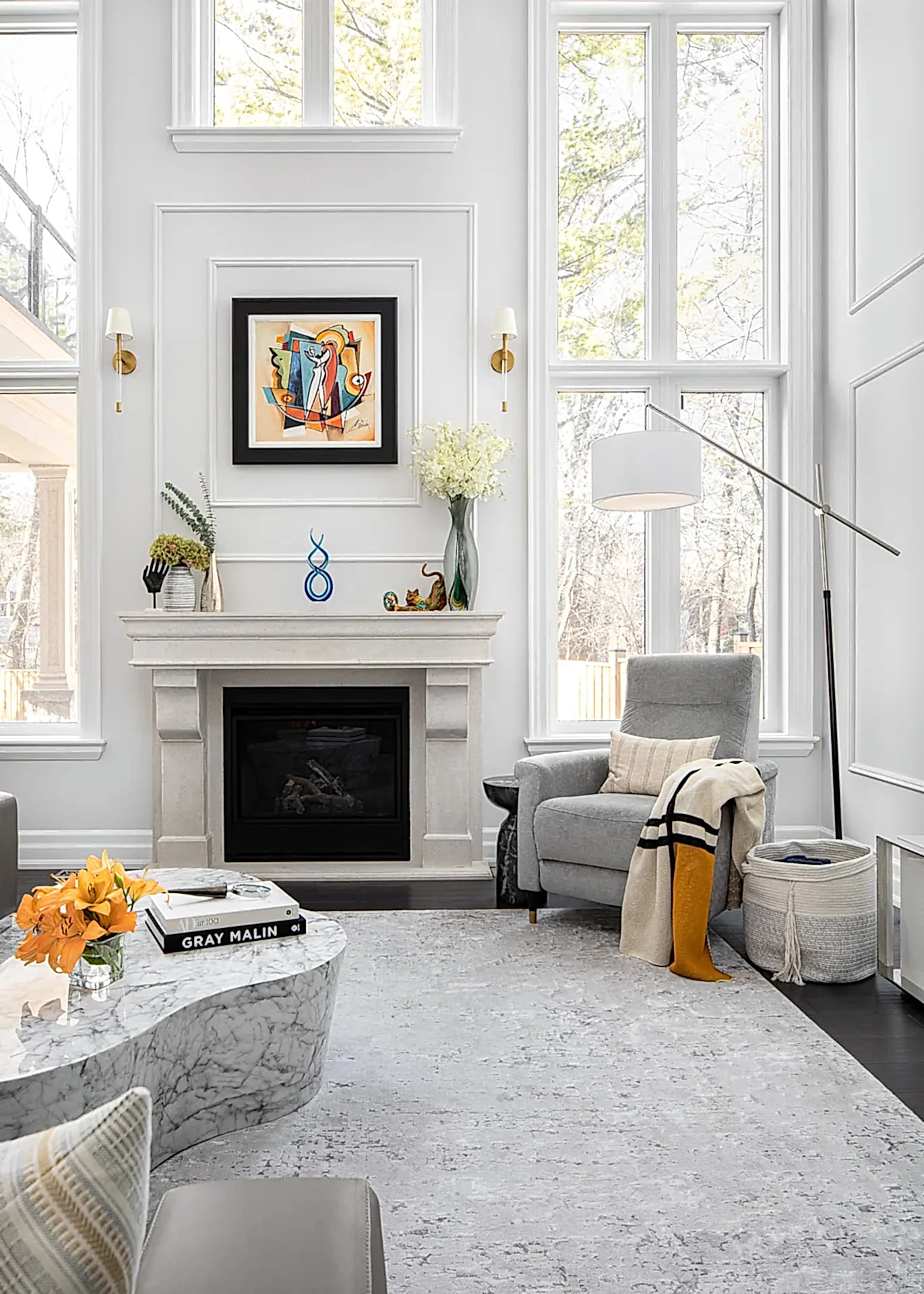 Bright modern transitional living room with curved sofa and gallery wall in Aurora Ontario