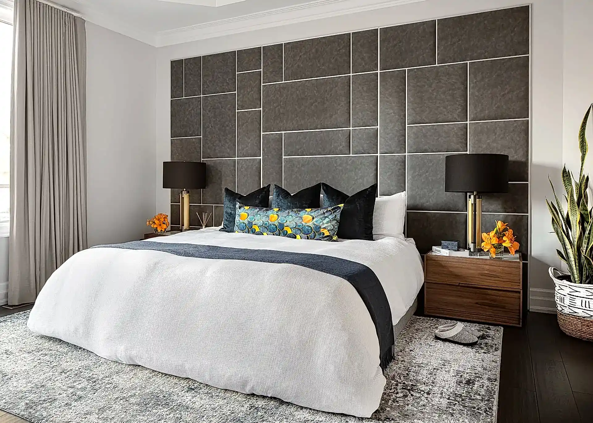 Modern transitional primary bedroom with king bed and large geometric upholstered headboard