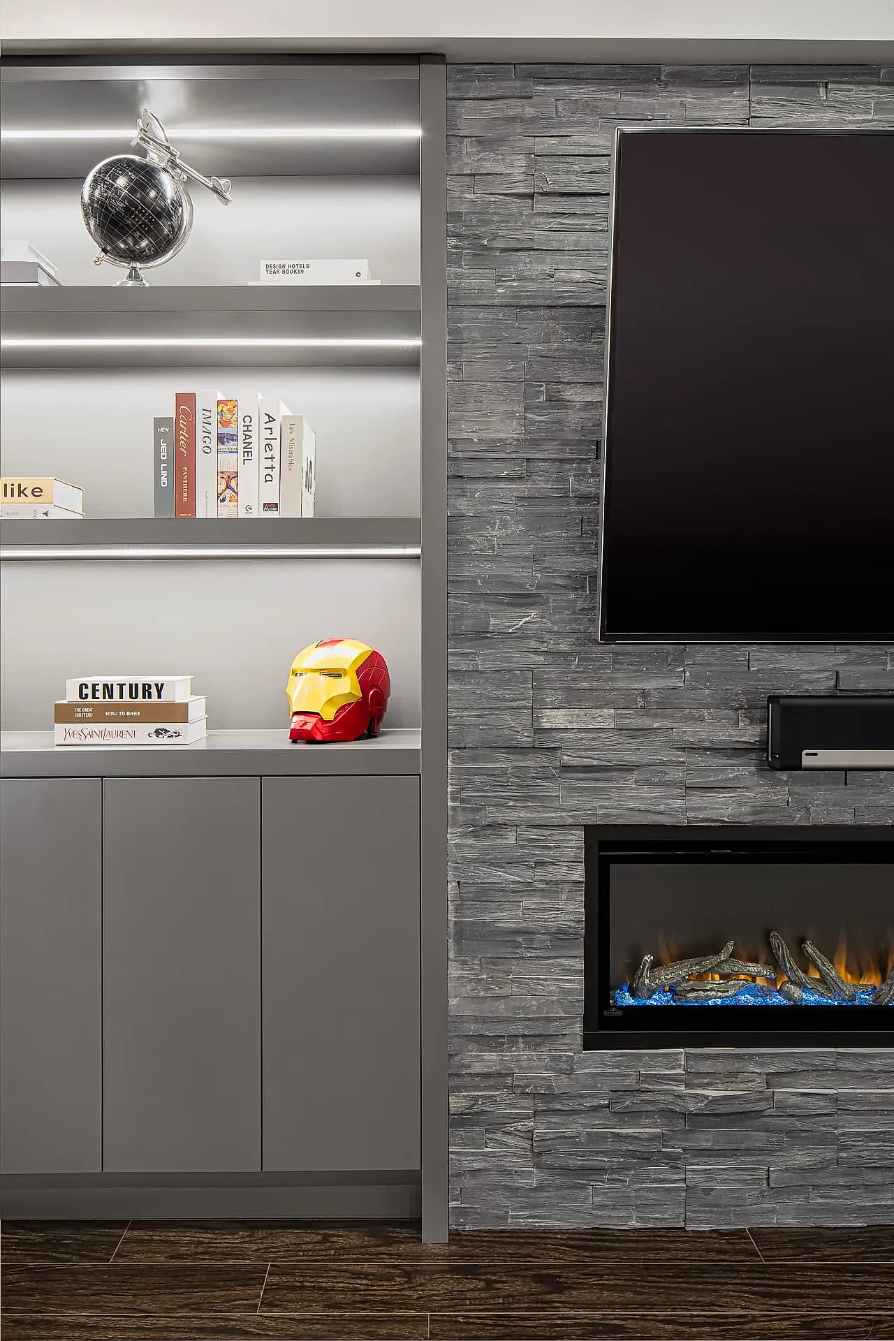 Modern living room with built-in bookcase and stone feature wall