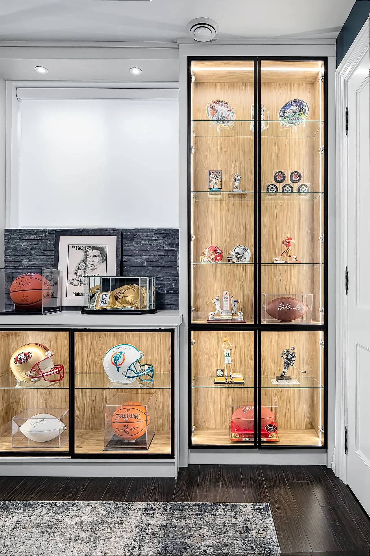 Bright modern home office with sports memorabilia display cabinet