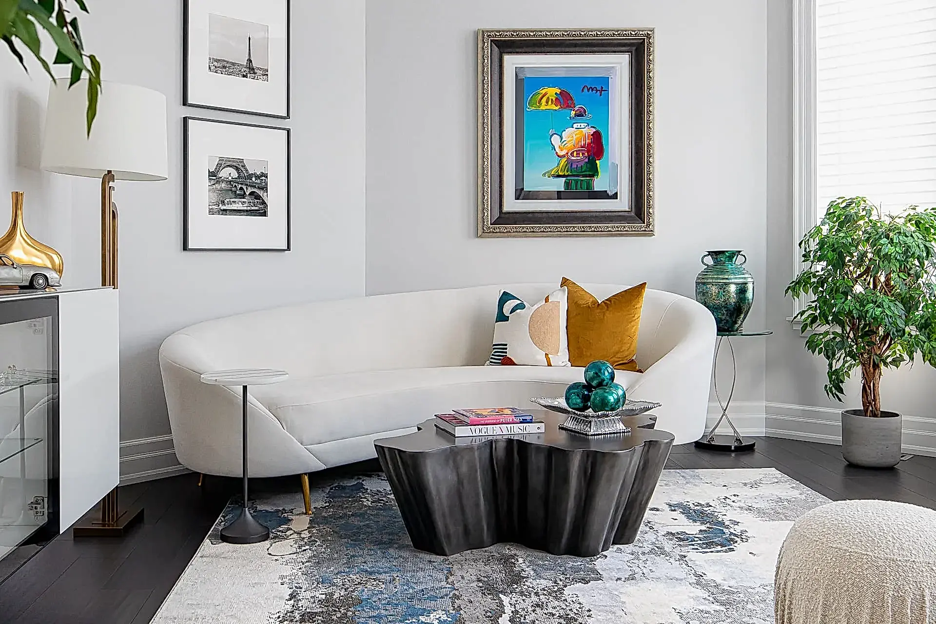 Bright modern transitional living room with curved sofa and gallery wall in Aurora Ontario