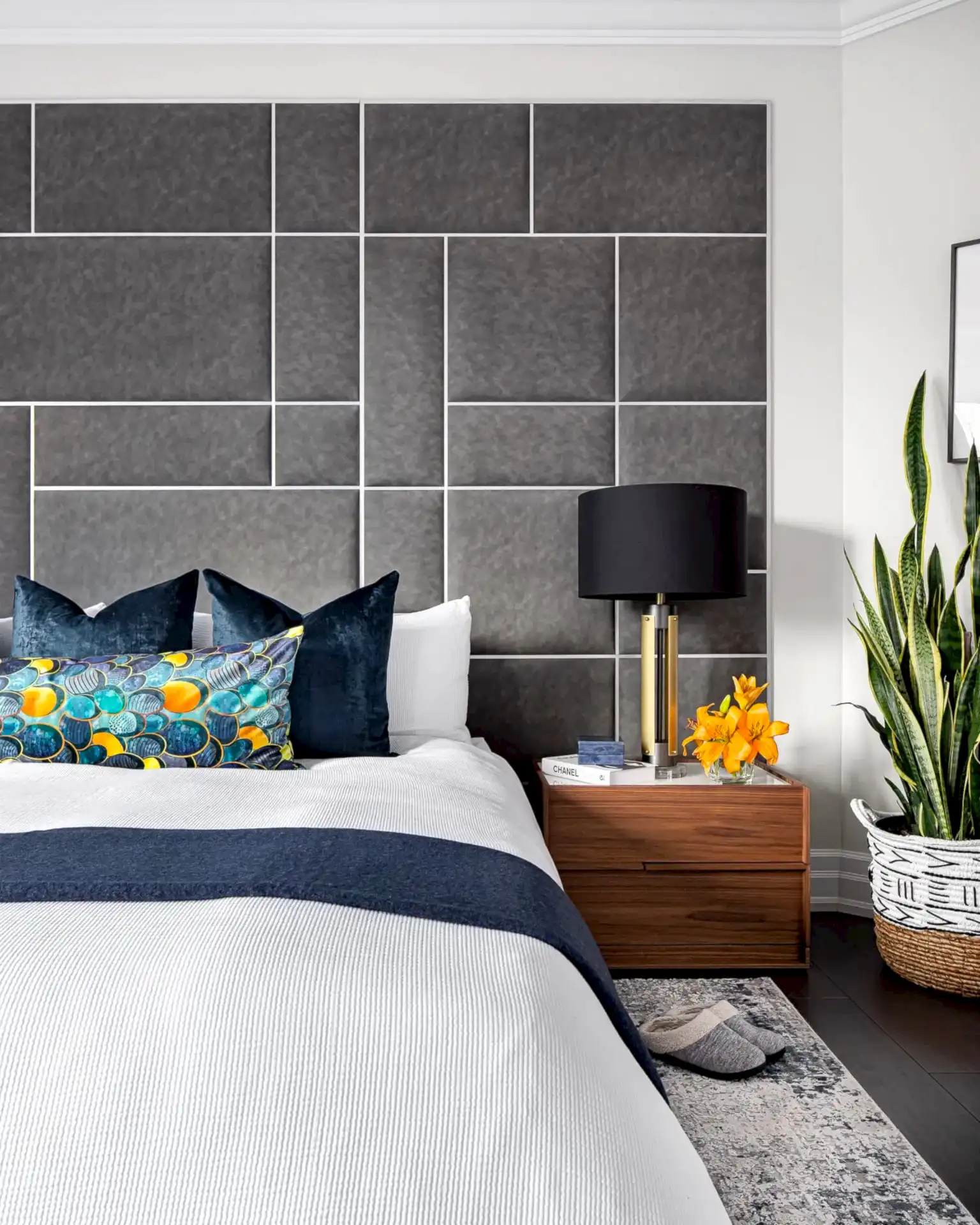 Modern transitional primary bedroom with king bed and large geometric upholstered headboard