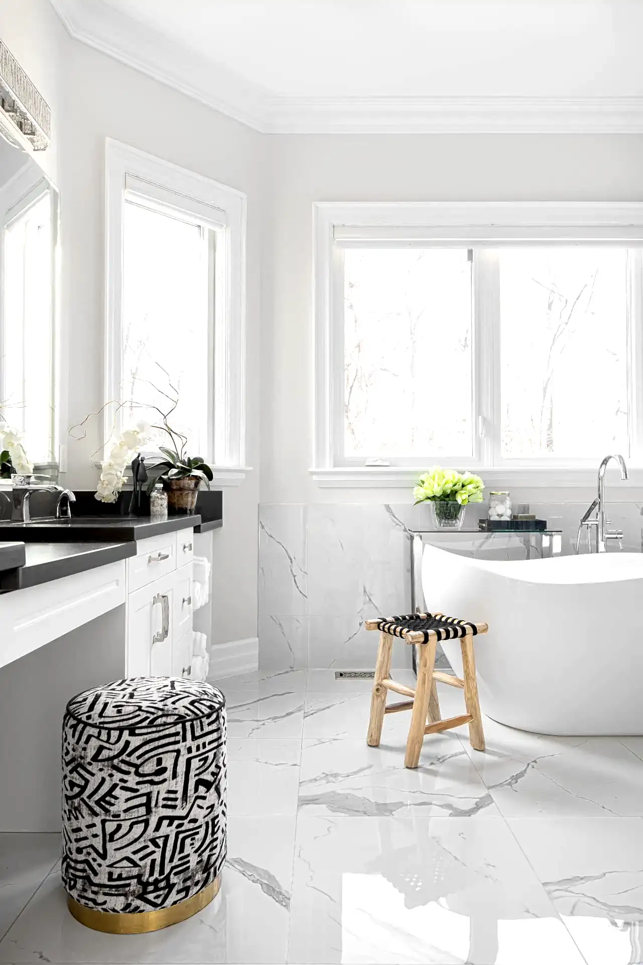 Bright white modern transitional en suite bathroom with soaker tub and black vanity